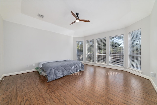 bedroom with dark hardwood / wood-style floors and ceiling fan