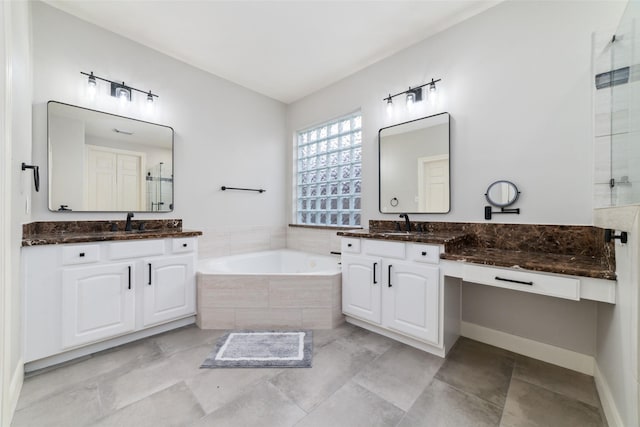 bathroom featuring vanity and shower with separate bathtub