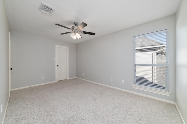 carpeted spare room featuring ceiling fan