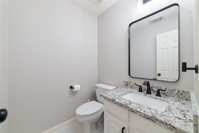 bathroom featuring vanity, toilet, and tile patterned flooring