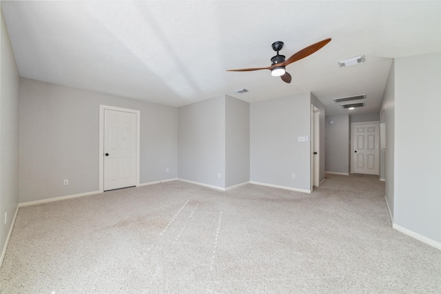 carpeted spare room featuring ceiling fan