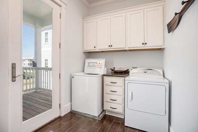clothes washing area featuring baseboards, cabinet space, ornamental molding, and wood finish floors