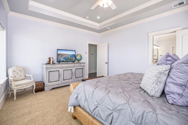 carpeted bedroom with ornamental molding, a raised ceiling, and ceiling fan