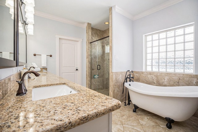 bathroom with vanity, crown molding, tile walls, and separate shower and tub