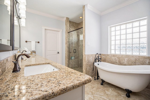 full bathroom with ornamental molding, a sink, a stall shower, and a freestanding bath
