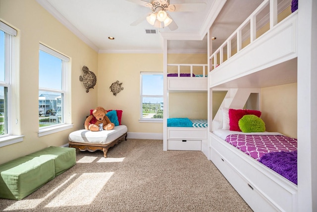 carpeted bedroom with ornamental molding and ceiling fan