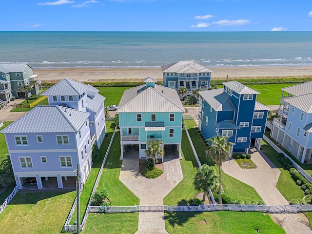 birds eye view of property with a water view and a view of the beach