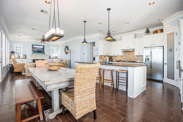 dining space featuring crown molding, recessed lighting, wood finish floors, ceiling fan, and visible vents