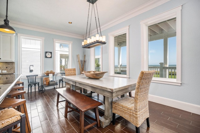 dining space featuring wood tiled floor, crown molding, baseboards, and a chandelier