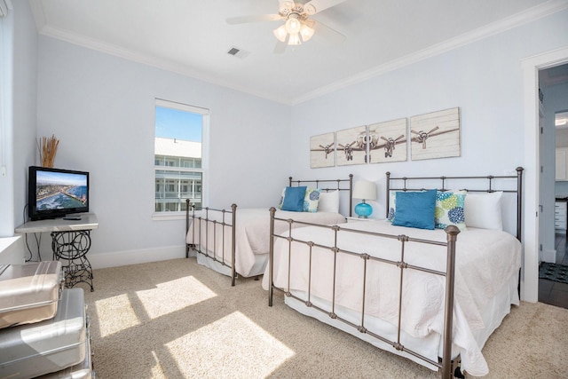 carpeted bedroom featuring crown molding and ceiling fan