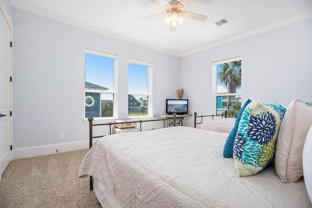 bedroom featuring a ceiling fan, carpet floors, crown molding, and baseboards