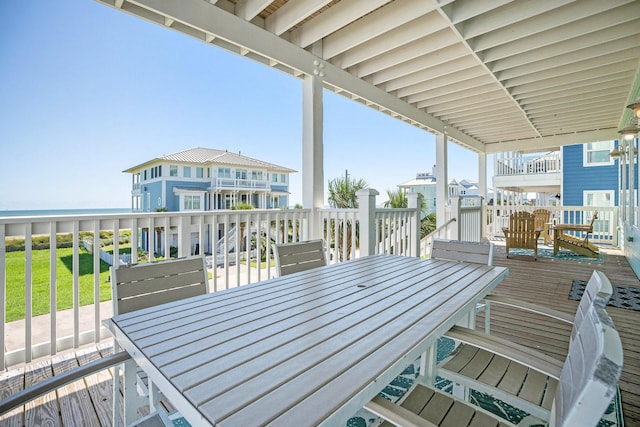 wooden terrace featuring a water view