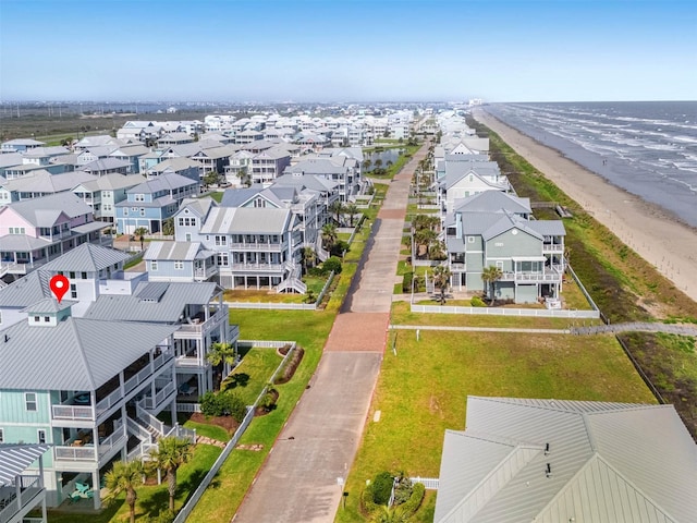 bird's eye view featuring a water view, a beach view, and a residential view