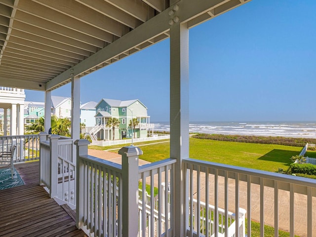 wooden deck with a residential view, a water view, and a yard