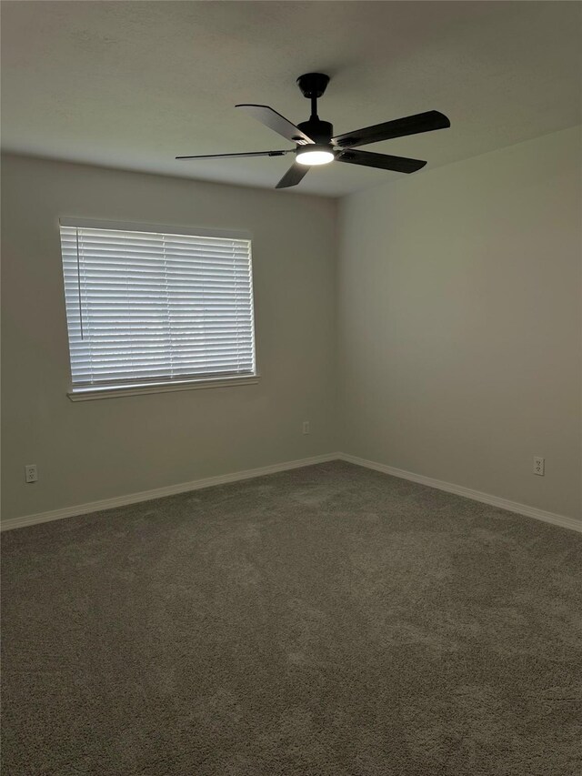 carpeted spare room with ceiling fan and plenty of natural light