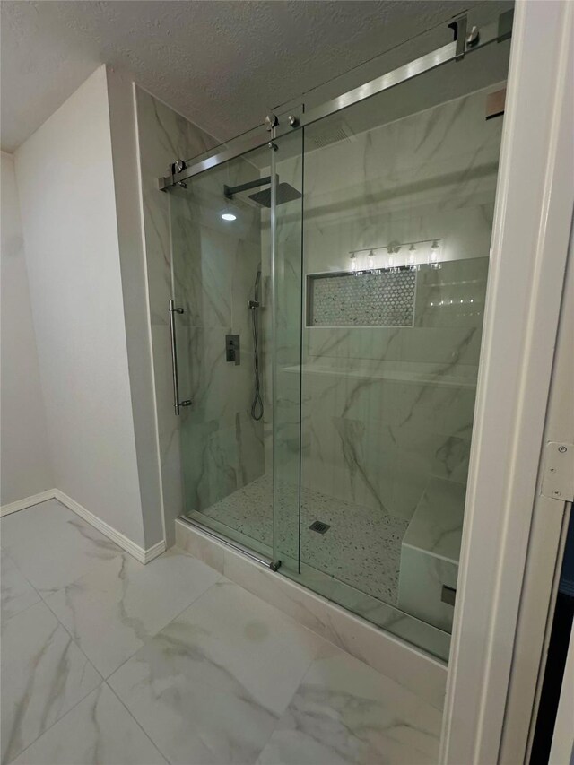 bathroom featuring a textured ceiling and an enclosed shower