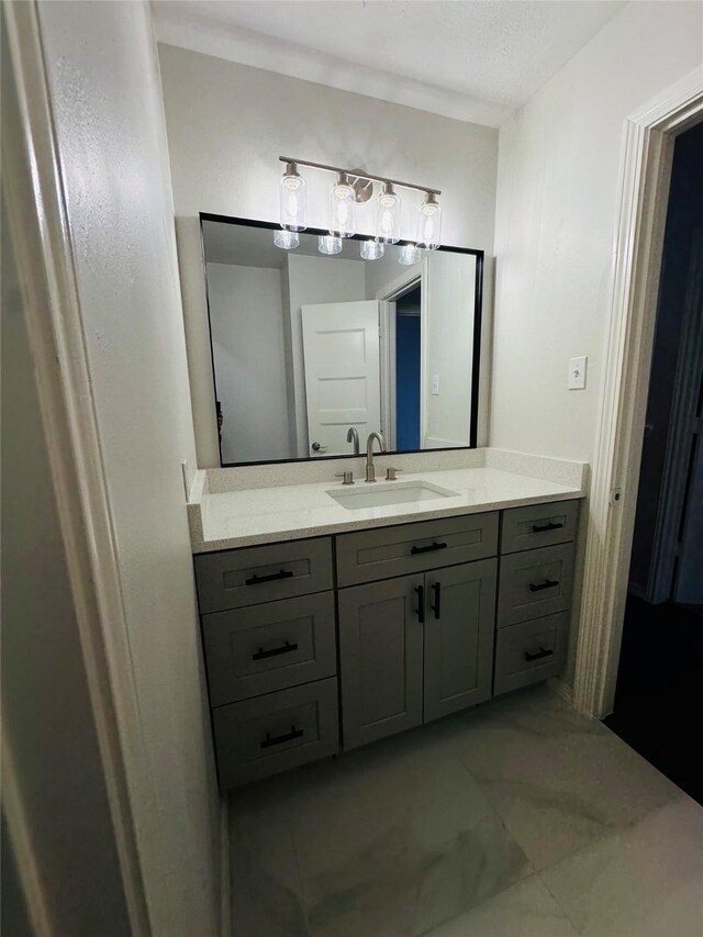 bathroom featuring a textured ceiling and vanity