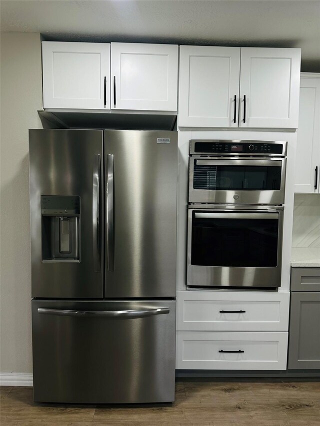 kitchen featuring white cabinetry, dark hardwood / wood-style floors, and appliances with stainless steel finishes