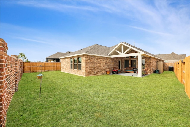 rear view of house featuring a patio area and a lawn