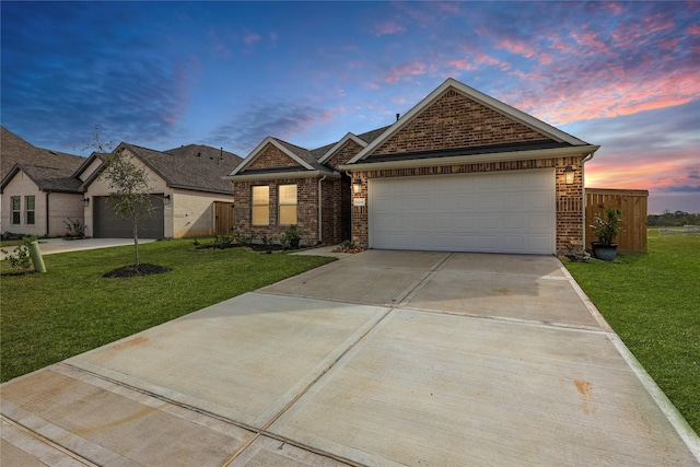 view of front of property featuring a lawn and a garage