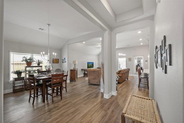 dining area featuring a notable chandelier, dark hardwood / wood-style floors, plenty of natural light, and lofted ceiling