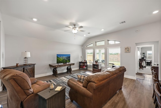 living room with ceiling fan, dark hardwood / wood-style floors, and vaulted ceiling