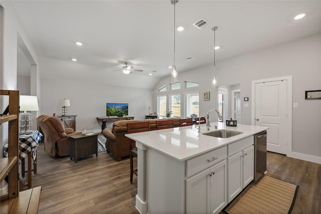 kitchen with decorative light fixtures, dishwasher, dark hardwood / wood-style flooring, and an island with sink