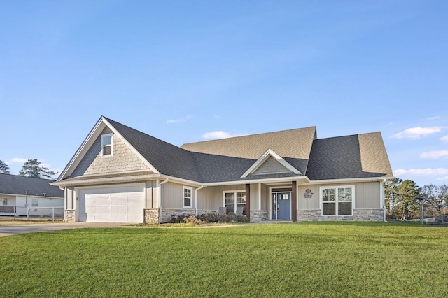 craftsman inspired home with a garage and a front lawn