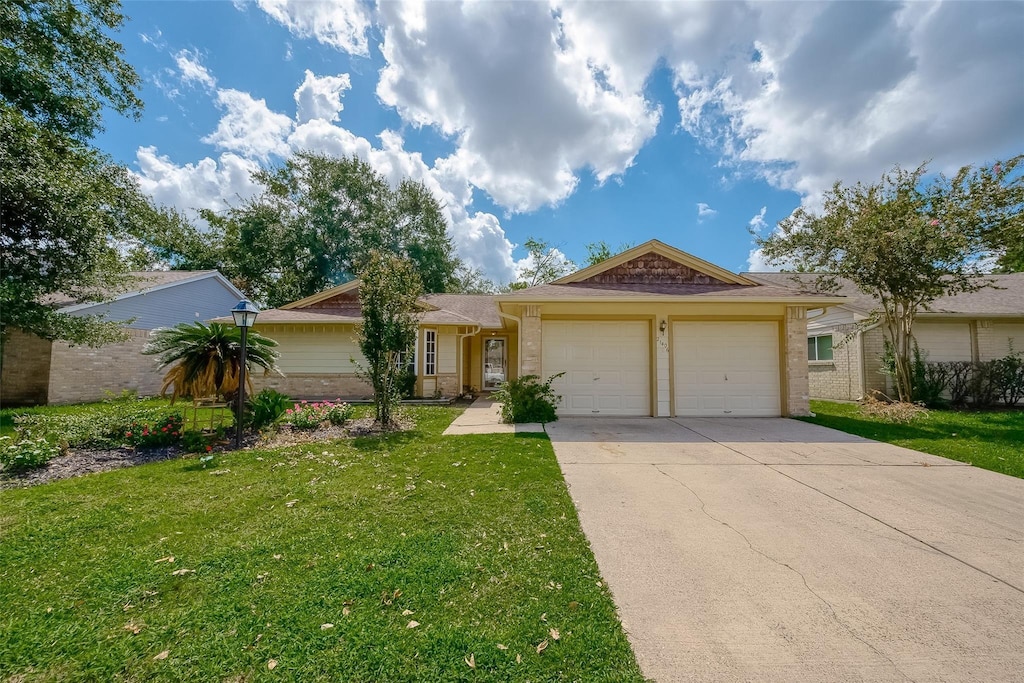 single story home featuring a garage and a front yard