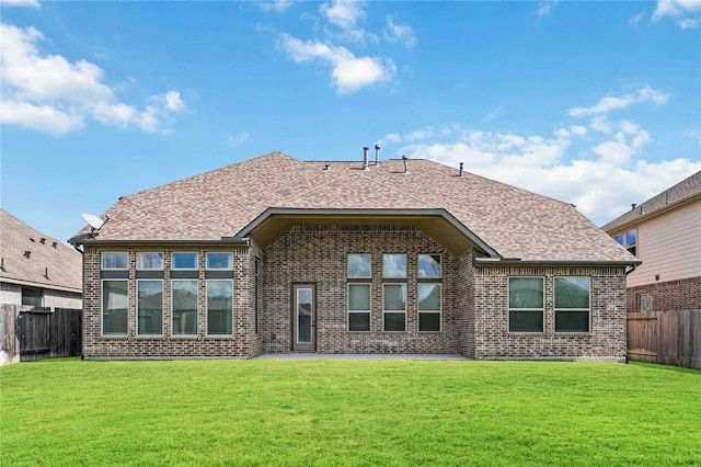 rear view of property featuring a yard