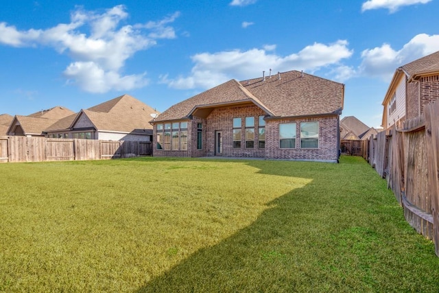 rear view of house with a lawn