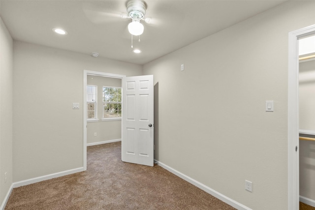 unfurnished room with ceiling fan and carpet floors