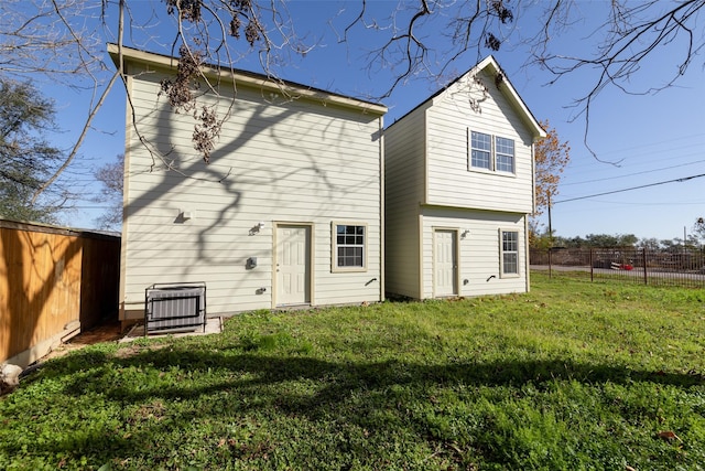 rear view of property with a yard