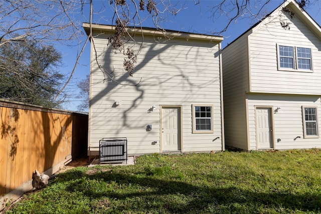 rear view of house with a yard and central air condition unit