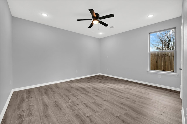 empty room featuring ceiling fan and light hardwood / wood-style flooring