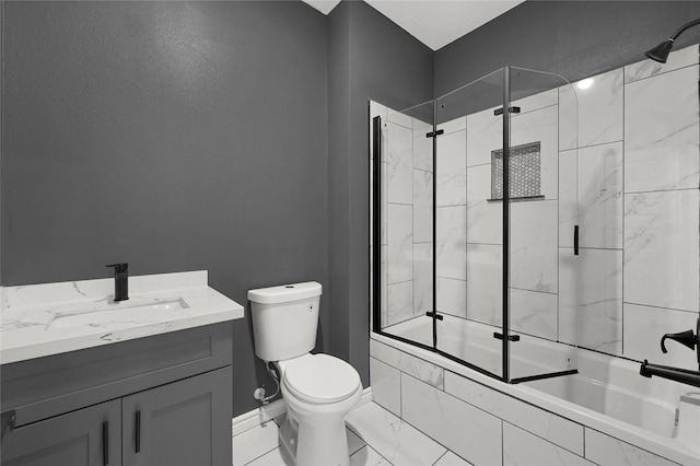 full bathroom featuring vanity, shower / bath combination with glass door, and toilet