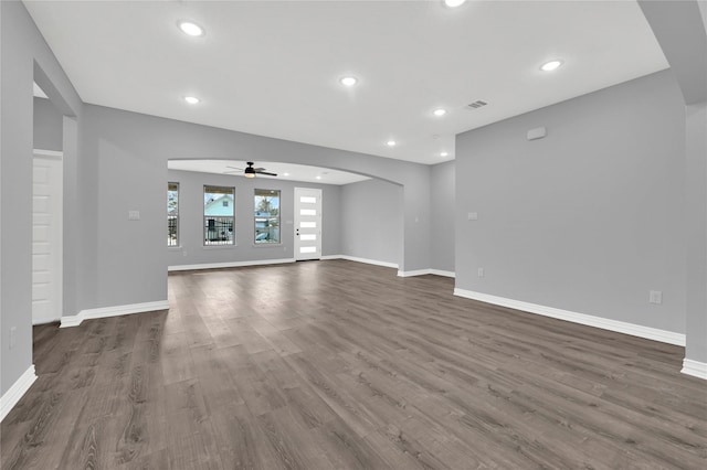 unfurnished living room featuring dark hardwood / wood-style floors and ceiling fan