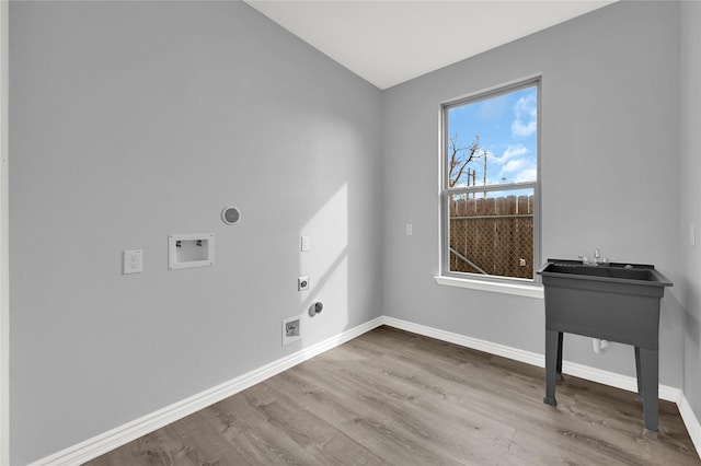 laundry room featuring hardwood / wood-style flooring, hookup for a washing machine, gas dryer hookup, and electric dryer hookup