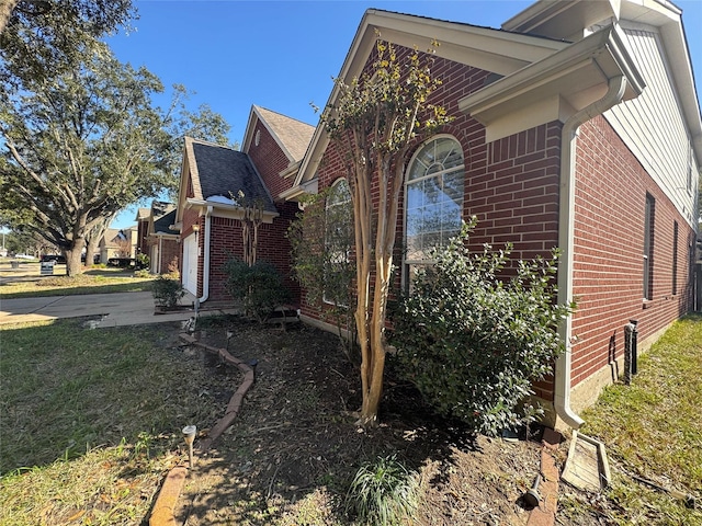 view of home's exterior featuring a yard and a garage