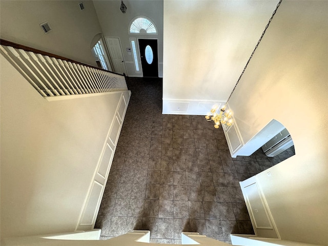 foyer with a chandelier and a high ceiling