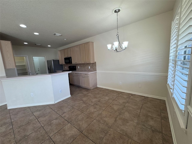 kitchen featuring decorative light fixtures, an inviting chandelier, light brown cabinetry, decorative backsplash, and stainless steel fridge