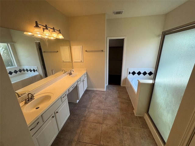 bathroom featuring a tub to relax in, tile patterned flooring, and vanity