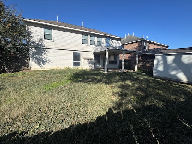 back of property featuring a yard