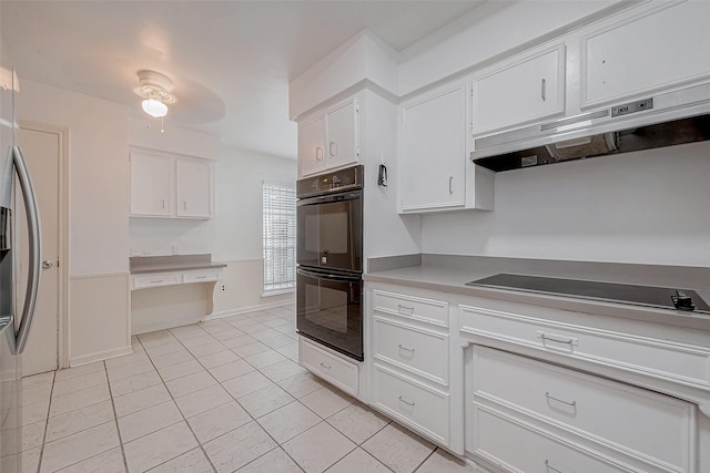 kitchen with white cabinetry, light tile patterned floors, and black appliances