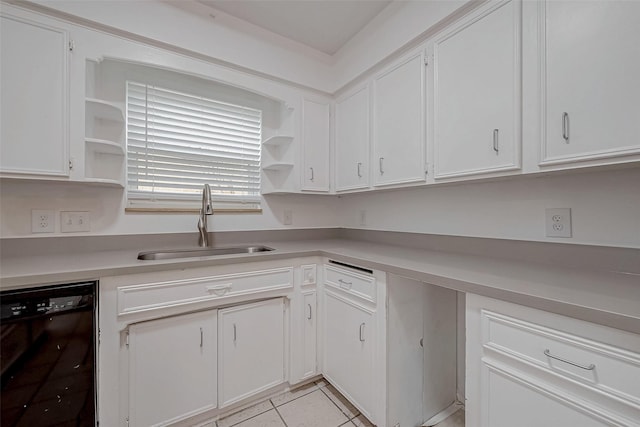 kitchen with white cabinetry, black dishwasher, sink, and light tile patterned floors