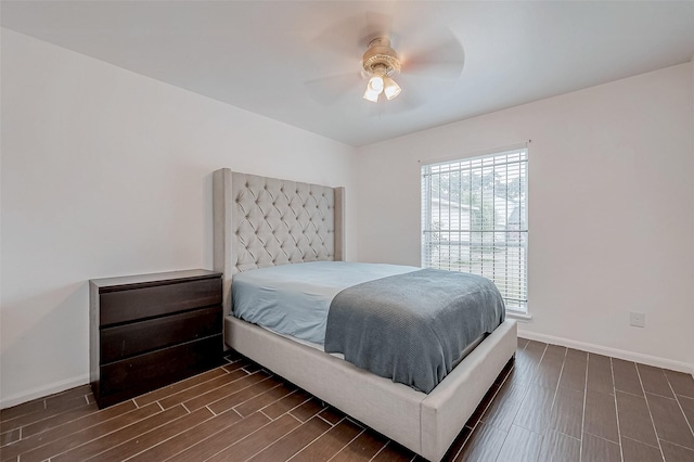 bedroom with dark hardwood / wood-style floors and ceiling fan