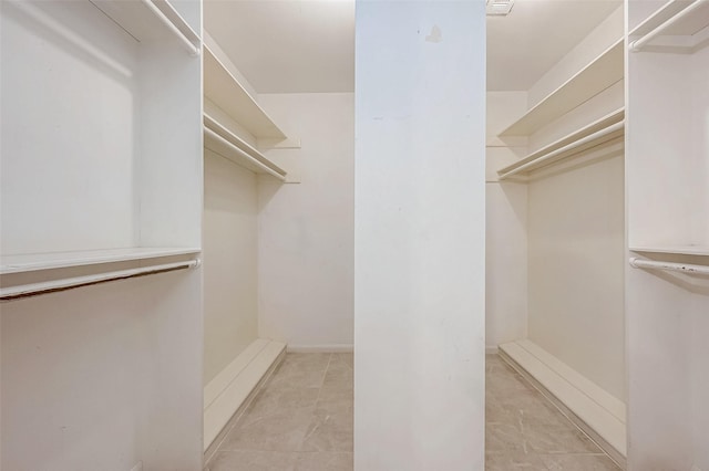 walk in closet featuring light tile patterned floors