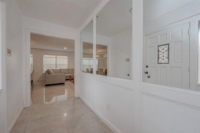 hallway featuring light tile patterned floors