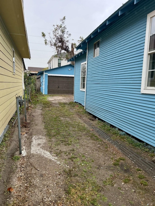 view of side of property featuring an outbuilding and a garage