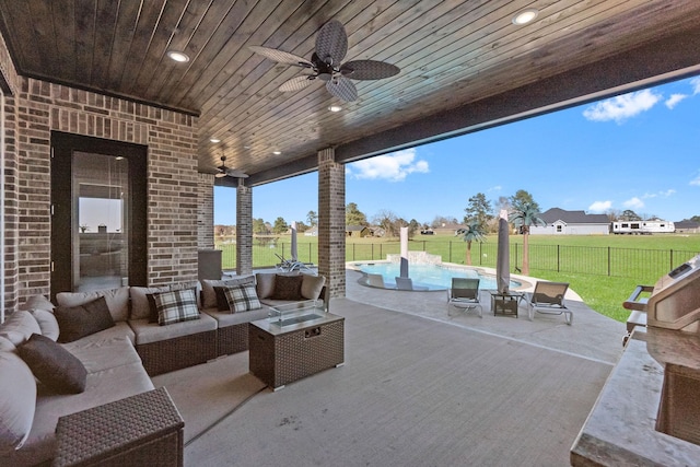 view of patio featuring an outdoor living space, a fenced in pool, and ceiling fan